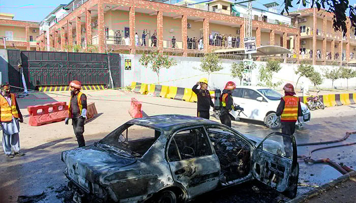 Firefighters douse a car at the suicide blast site in Islamabad on November 11, 2025. — AFP