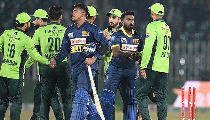 Sri Lankas Maheesh Theekshana (centre left) and Sri Lankas Asitha Fernando (centre right) shake hands with Pakistans players at the end of the first ODI cricket match between Pakistan and Sri Lanka at the Rawalpindi Cricket Stadium, November 11, 2025. — AFP