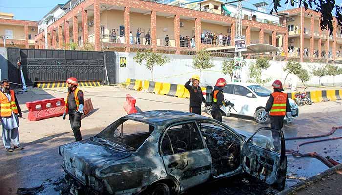 Firefighters douse a car at the suicide blast site in Islamabad on November 11, 2025. — AFP