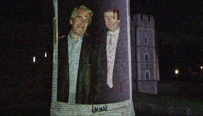 This frame grab made on September 17, 2025, from an AFP video footage dated from September 16, 2025 shows an image projected onto a tower of the Windsor Castle bearing a portrait of notorious sex offender Jeffrey Epstein and US President Donald Trump. — AFP