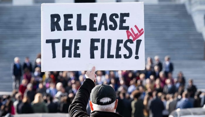 A protester holds a sign related to the release of the Jeffrey Epstein case files outside the US Capitol in Washington, DC, November 12, 2025. — AFP