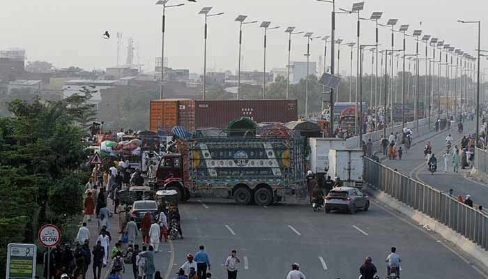 Trucks and containers block Ravi Bridge as supporters of Tehreek-e-Labbaik Pakistan (TLP) march during a solidarity march for Gaza in Lahore, October 10, 2025. — Reuters