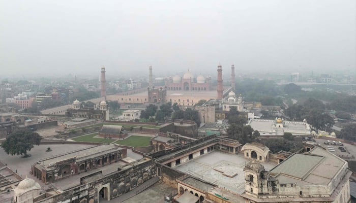 An aerial view shows the Badshahi Mosque engulfed in dense smog in Lahore on November 4, 2025. — AFP