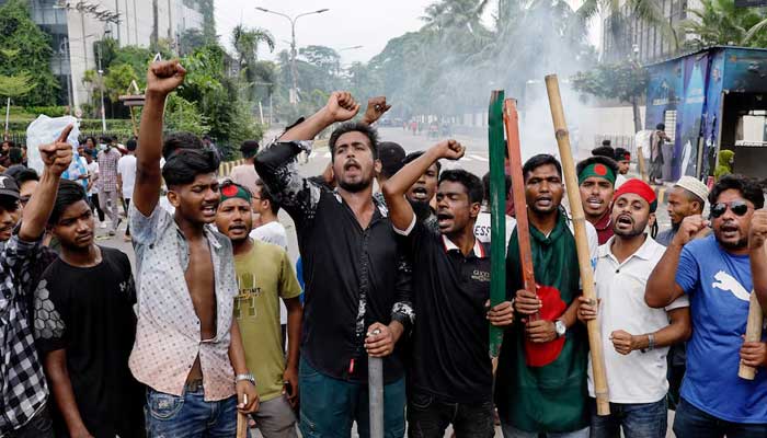 Demonstrators shout slogans after they have occupied a street during a protest demanding the stepping down of Sheikh Hasina, following quota reform protests by students, in Dhaka, Bangladesh, August 4, 2024. — Reuters
