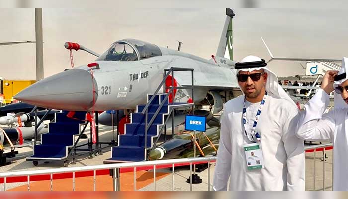 Visitors take photo with Pakistans JF-17 Thunder multirole fighter jet at Dubai Airshow 2025, Al Maktoum International Airport. — Reporter