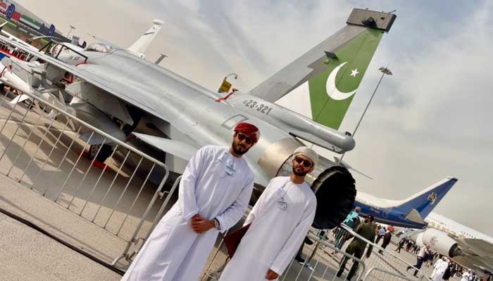 Visitors take photo with Pakistans JF-17 Thunder multirole fighter jet at Dubai Airshow 2025, Al Maktoum International Airport. — Reporter