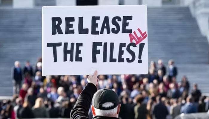 A protester holds a sign related to the release of the Jeffrey Epstein case files outside the US Capitol in Washington, DC, on November 12, 2025. — Reuters