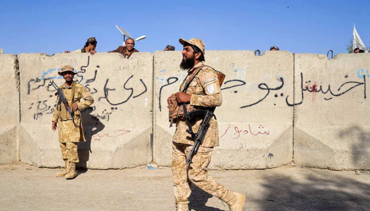 Armed Taliban security personnel keep guard near the closed gate of the zero point border crossing between Afghanistan and Pakistan at Spin Boldak district in Kandahar province on October 12, 2025. — AFP