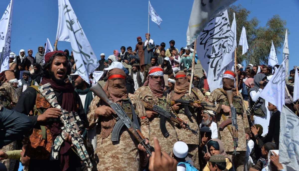Members of the Afghan Taliban and villagers celebrate the peace deal and their victory in the Afghan conflict in the Alingar district of Laghman Province on March 2. — AFP/File