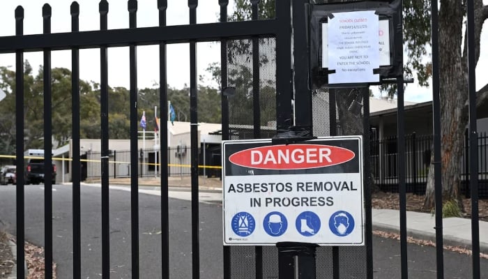 An asbestos warning sign is displayed at Black Mountain School in Canberra, Australia, November 17, 2025. — Reuters