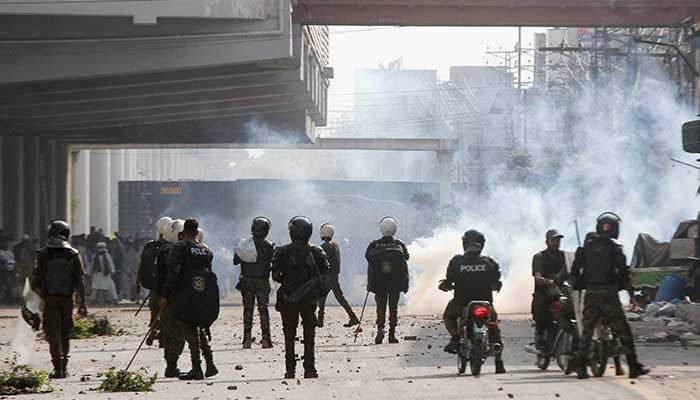 Police officers stand as they use tear gas to disperse supporters of Tehreek-e-Labbaik Pakistan (TLP) during a solidarity march for Gaza in Lahore, Pakistan, October 10, 2025. — Reuters