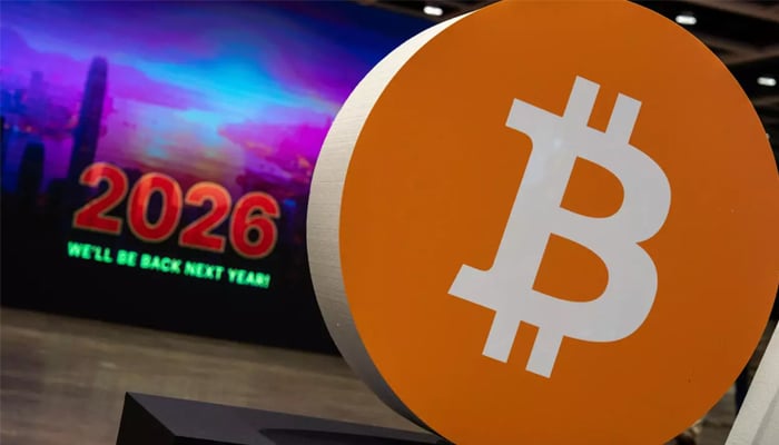 A large Bitcoin symbol displayed at a trade show and a screen with “2026” written on it along with the message “We’ll be back next year in this undated picture. — AFP