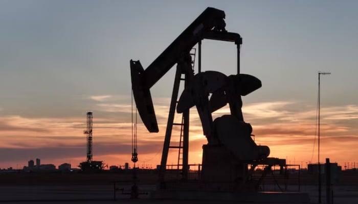A drone view of a pump jack and drilling rig south of Midland, Texas, United States. — Reuters/File