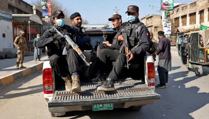 Security personnel ride in a vehicle heading to the site of an attack in Peshawar. — Reuters/File
