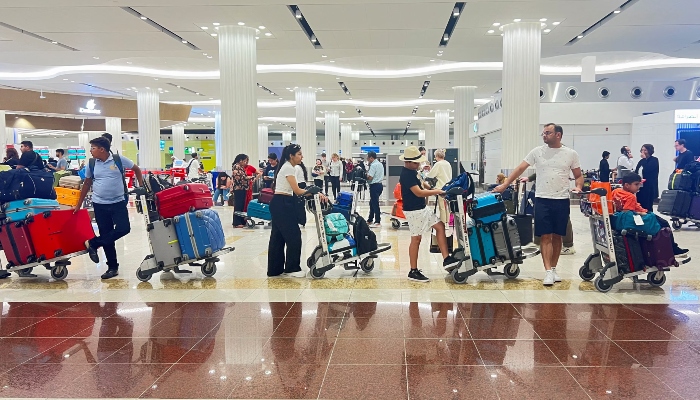 People queue at the check-in counter at the Dubai International Airport, in Dubai, United Arab Emirates, April 17, 2024. — Reuters