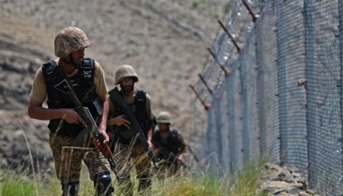 Pakistani troops patrol along Pakistan-Afghanistan border fence in the Khyber district of Khyber Pakhtunkhwa. — AFP/File