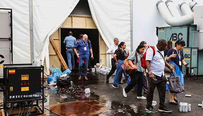 People are evacuated following a fire alert during the UN Climate Change Conference (COP30), in Belem, Brazil, November 20, 2025. — Reuters