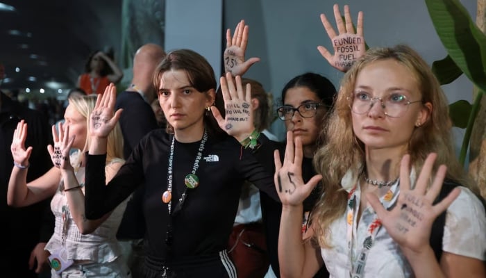 Activists show messages written on their hands as they take part in a protest while COP 30 negotiators leave the meeting room, during the UN Climate Change Conference (COP30), in Belem, Brazil, November 21, 2025. — Reuters