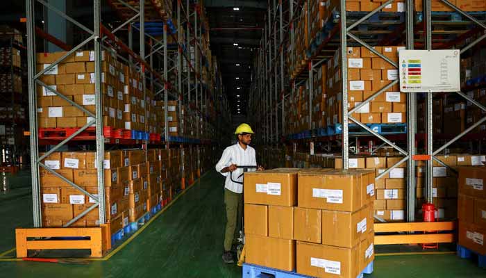 A labourer uses a pallet truck to shift boxes at the Jan Aushadhi Central Warehouse during an organised media tour to show key operations of the Pradhan Mantri Bhartiya Janaushadhi Pariyojana (PMBJP), a government scheme that provides generic medicines at affordable prices, in Gurugram, India, November 21, 2025. — Reuters