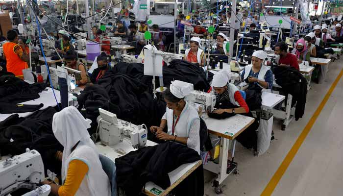Workers stitch hoodies in a garment manufacturing unit on the outskirts of Ahmedabad, India, August 5, 2025. — Reuters