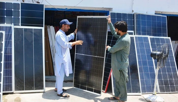 A customer purchasing solar panel from a vendor at the Station Road, Hyderabad on May 14, 2024. — APP