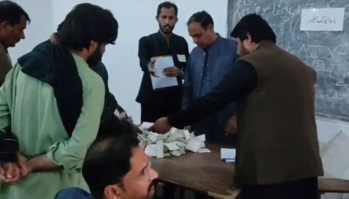 Polling staff count ballots after the end of the voting in by-election on November 23, 2025. — Geo News