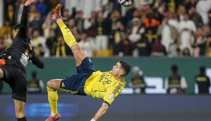 Nassrs Portuguese forward Cristiano Ronaldo (R) kicks the ball to score his teams fourth goal during the Saudi Pro League football match between Al-Nassr and Al-Khaleej at Al-Awwal Park in Riyadh on November 23, 2025. — AFP