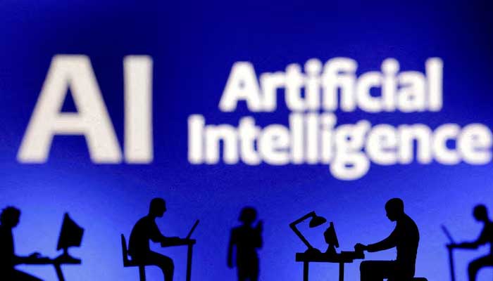 Figurines with computers and smartphones are seen in front of the words Artificial Intelligence AI in this illustration. — Reuters/File