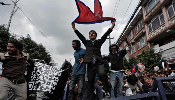 Demonstrators shout slogans as they stand on a barricade during a protest against corruption and the government’s decision to block several social media platforms, in Kathmandu, Nepal on September 8, 2025. — Reuters