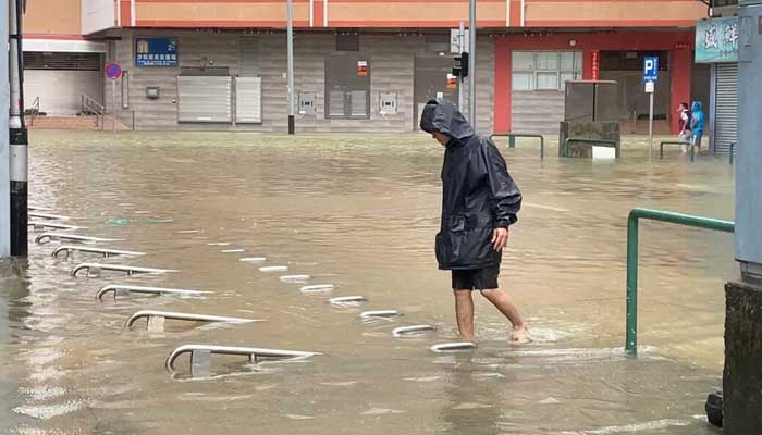 A man walks in a waterlogged street in the aftermath of Super Typhoon Ragasa in Macau, China, on September 24, 2025. — Reuters