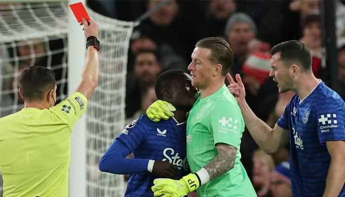 Evertons Idrissa Gueye is held back by Evertons Jordan Pickford as he clashes with teammate Michael Keane and shown a red card by referee Tony Harrington during Premier League clash against Manchester United at Old Trafford, Manchester, Britain, November 24, 2025. — Reuters