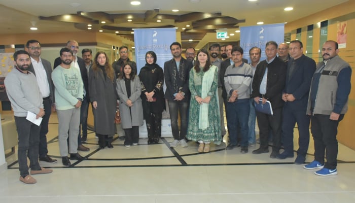 Group photo of journalists with Agha Khan Development Project officials and filmmaker Jawad Sharif. — Reporter