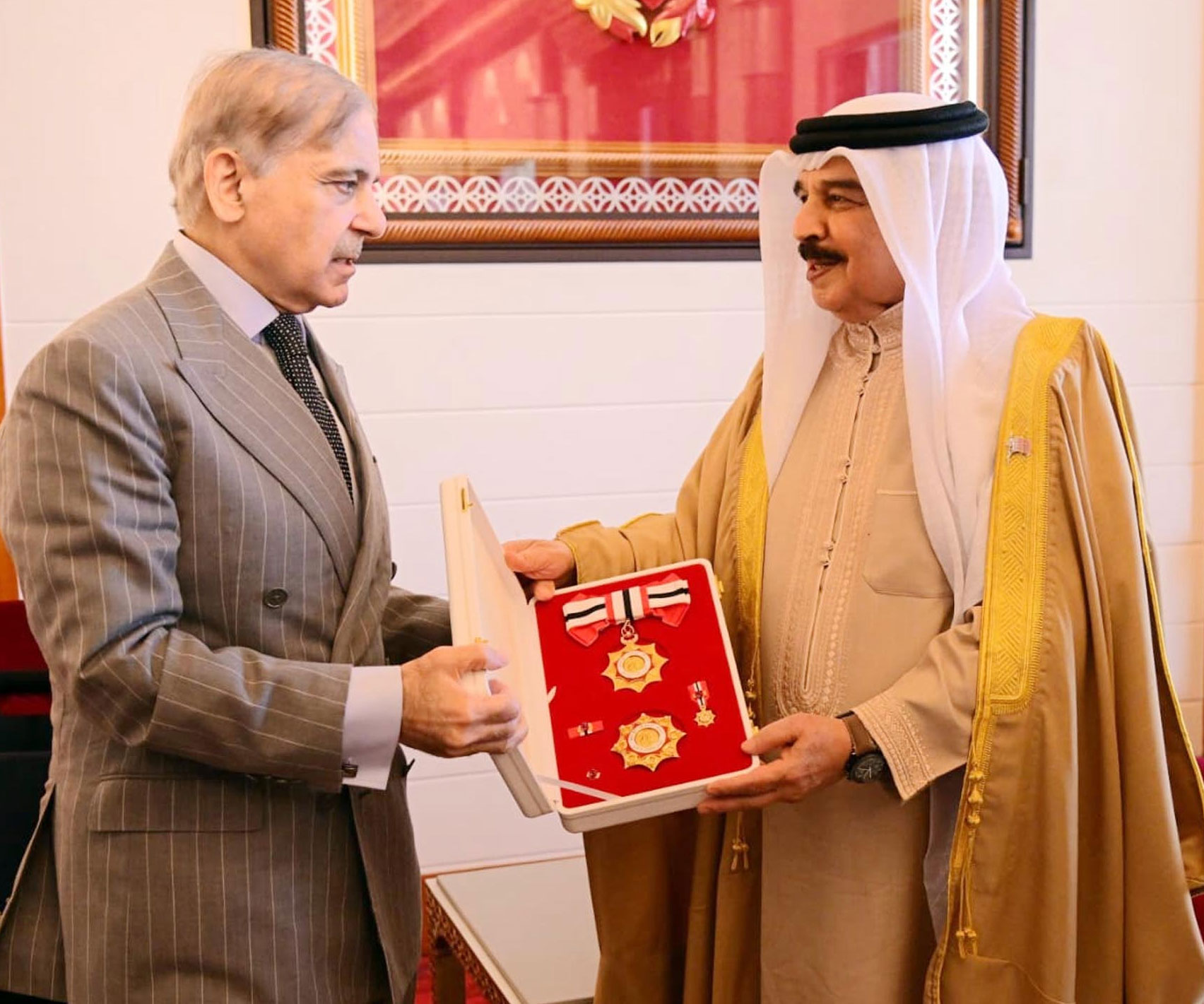 Bahrain’s King Hamad bin Isa Al-Khalifa (right) confers the Order of Bahrain (First Class) Upon Prime Minister Shehbaz Sharif in Manama on November 26, 2025. — PID