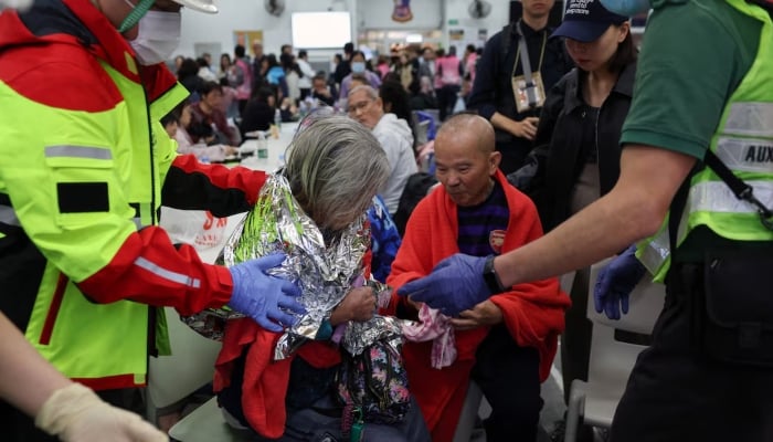 A woman receives medical attention at a temporary shelter after a fire broke out across multiple buildings at the Wang Fuk Court housing estate in Tai Po, Hong Kong, China, November 26. — Reuters