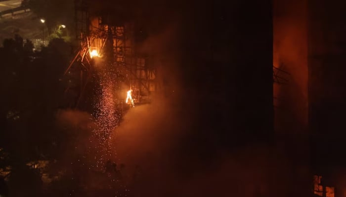 A fire burns bamboo scaffolding on a building at Wang Fuk Court housing estate, in Tai Po, Hong Kong, China, November 26. — Reuters
