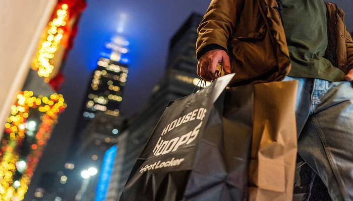 A man carries his shopping bags during the holiday season in New York City, US, December 10, 2023. — Reuters