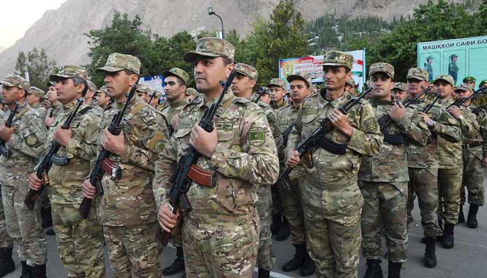 Tajik service members take part in a military parade near the Tajikistan border with Afghanistan. — Reuters/File