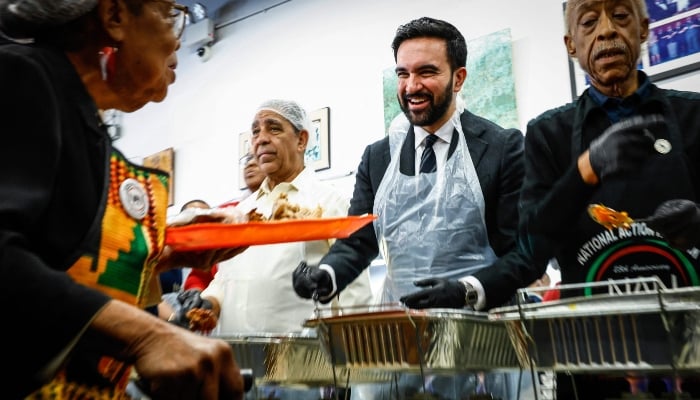 New York City mayor-elect Zohran Mamdani and Reverend Al Sharpton serve meals at the National Action Network (NAN) Annual Thanksgiving Feeding event in Harlem, New York City, US, on Thanksgiving Day, November 27, 2025. — AFP