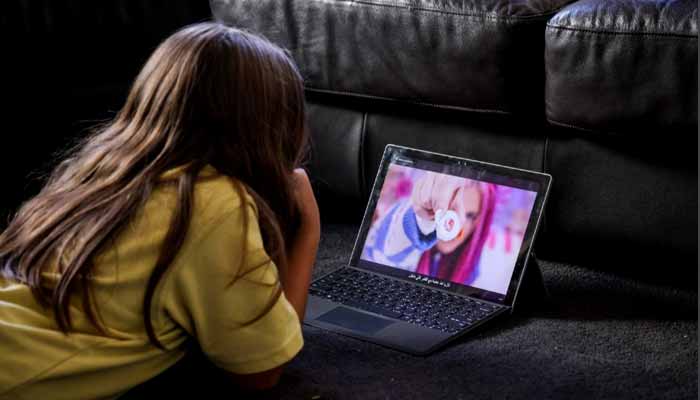 A 10-year-old girl watches a show on YouTube at her home in western Sydney. — AFP
