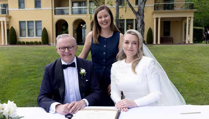Australian Prime Minister Anthony Albanese (Left) and his new wife Jodie Haydon (Right) sign the marriage certificate with celebrant Bree during their wedding ceremony in Canberra on November 29, 2025. — AFP