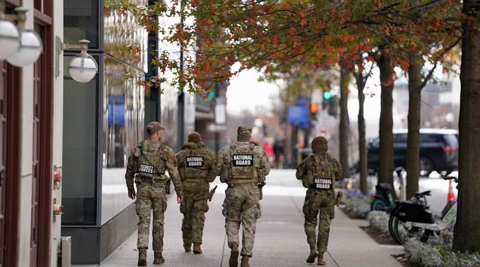 US halts asylum decisions as troop killing sparks migrant crackdown