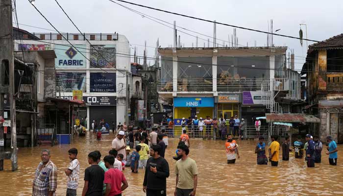 People gather at an area affected by floods, following heavy rainfall in Malwana, Sri Lanka on November 29, 2025. — Reuters