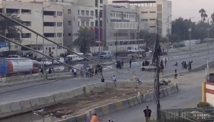 Residents protest after a three-year-old boy falls into open manhole in Karachi on November 30, 2025. — Screengrab via Geo News