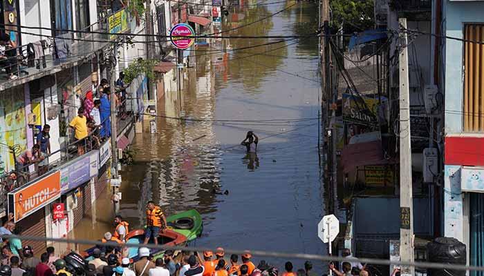 A man wades through the flooded street, following heavy rainfall in Wellampitiya, Sri Lanka, November 30, 2025. — Reuters