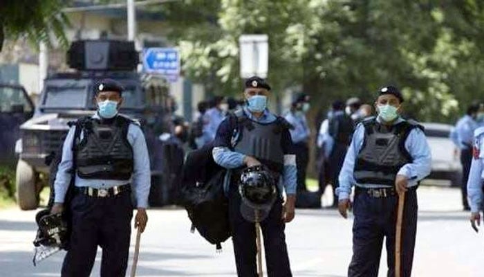 Police personnel stand alert on a road in Islamabad. — Radio Pakistan/File
