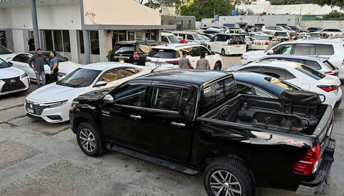 Vehicles are parked at a car dealers showroom in Karachi. — AFP/File