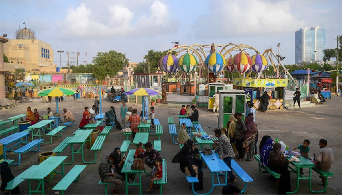 People enjoy during a funfair at an amusement park in Karachi. — AFP/File