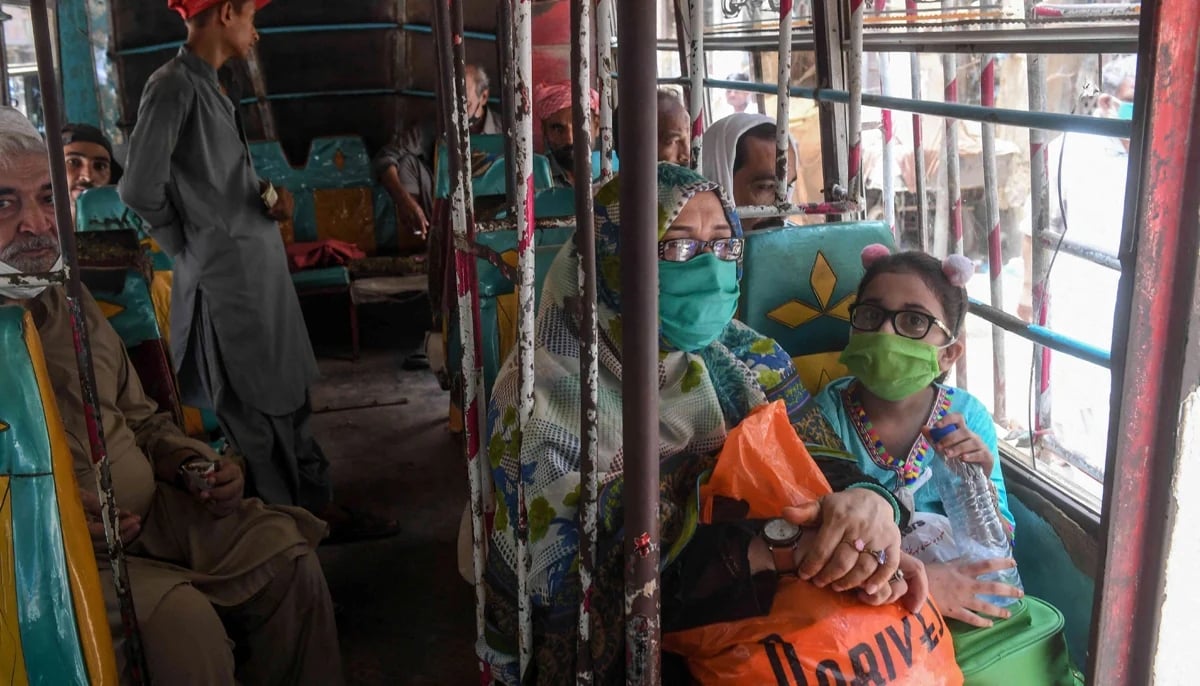 Women are seated in a public bus in Karachi. — AFP/File