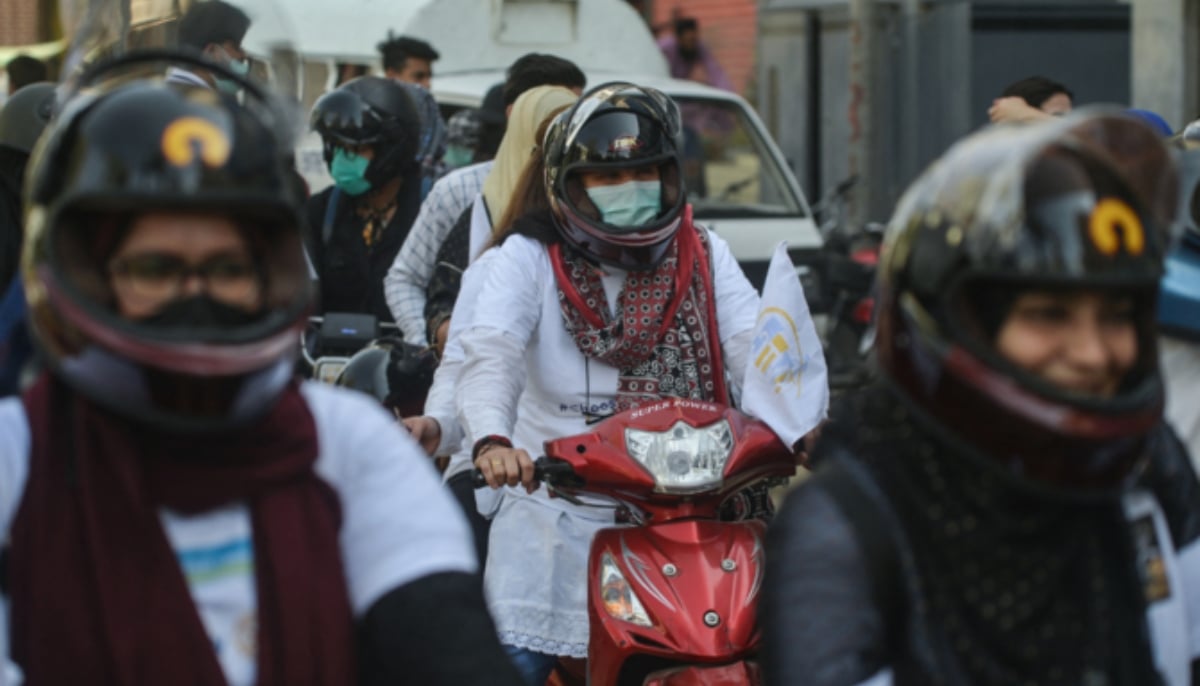 Women bikers participate in a women bike rally in Karachi on March 7, 2021. — AFP