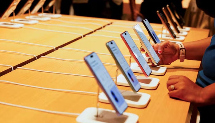 A person holds an Apple iPhone at the companys first retail store in Bengaluru, India, September 2, 2025. — Reuters